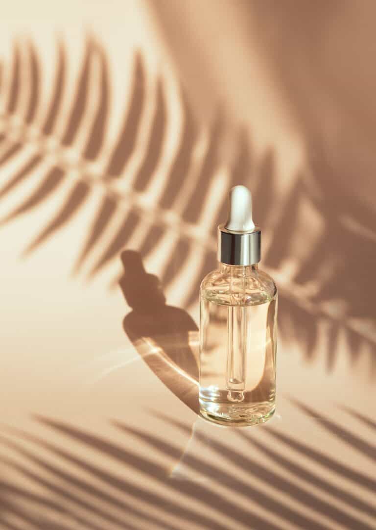 serum on beige background with natural shadow