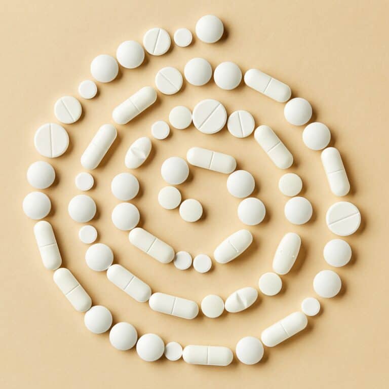 white medicine pills on beige background